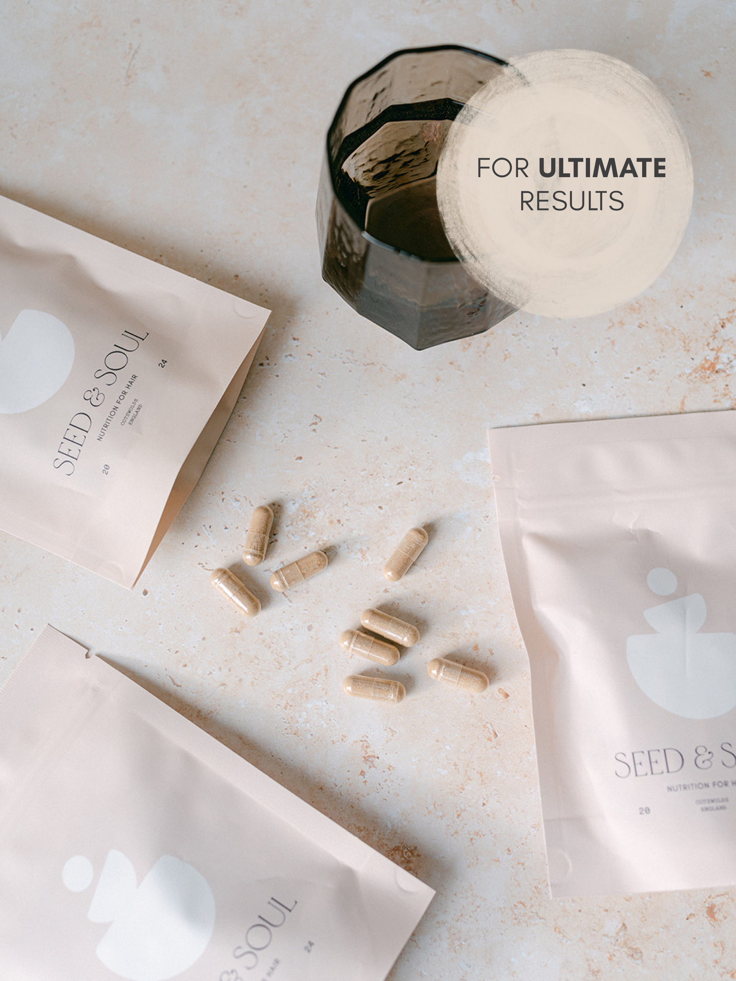 A flat lay of nutritional supplement capsules, seed and soul product packaging, and some additional packaging on a light-colored surface.