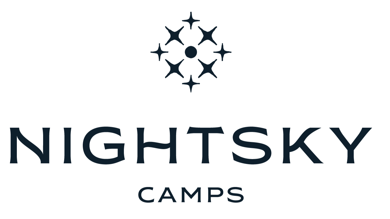 Night Sky Camps logo featuring a circular constellation of seven stylized stars above the words "Night Sky" in large font and "Camps" below in smaller font.