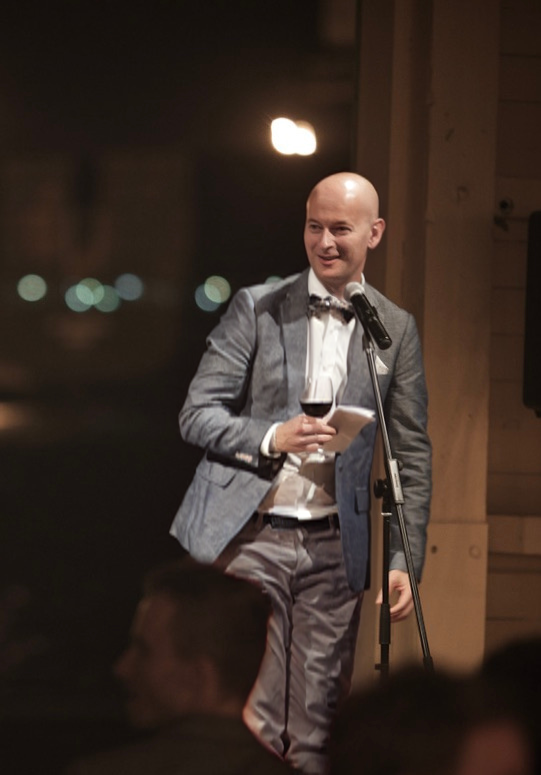 Adam Mitchell, (Perth Celebrant & MC) speaking into a microphone