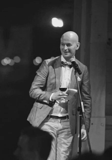 Adam Mitchell, (Perth Celebrant & MC) speaking into a microphone