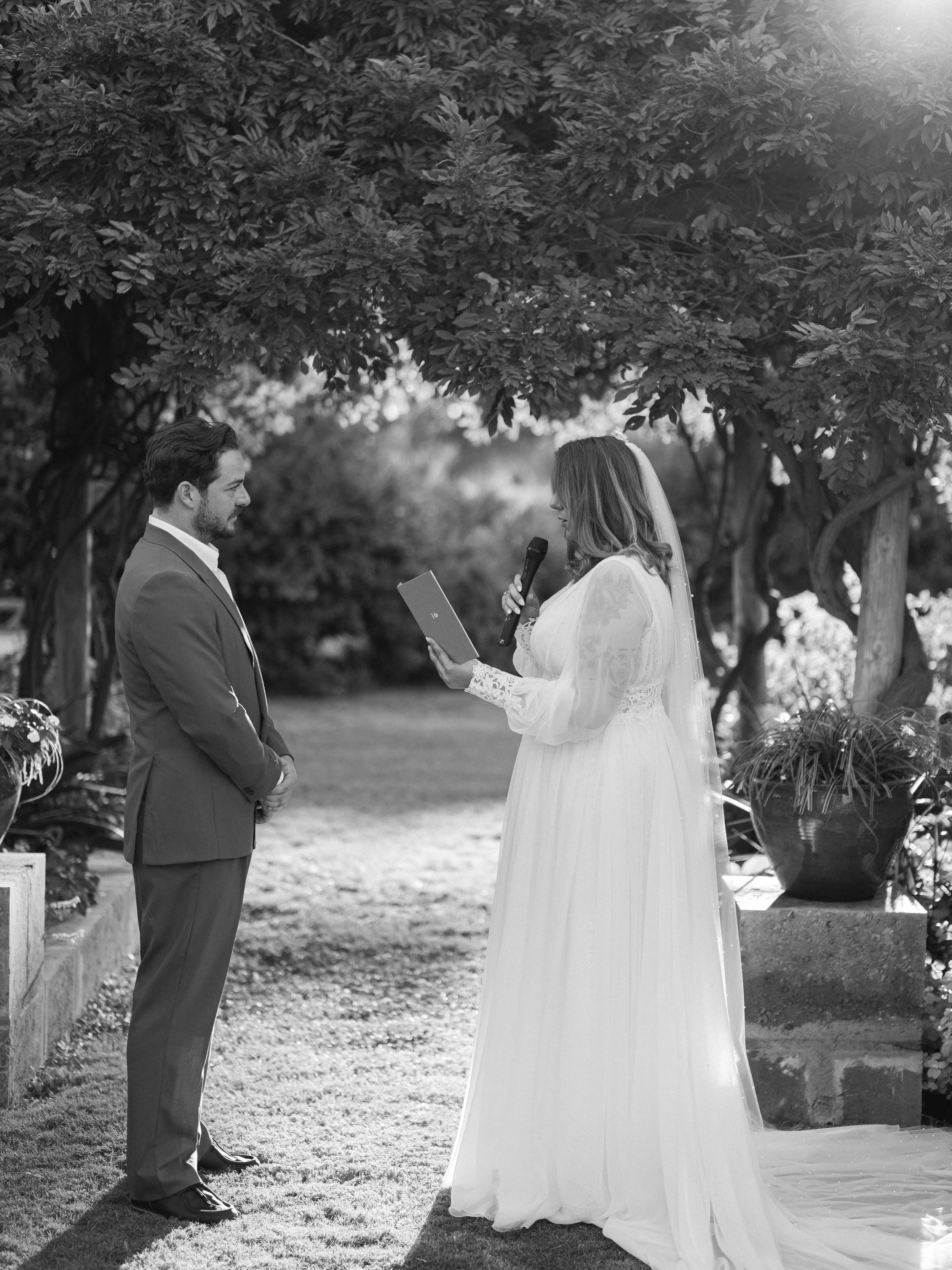 A happy couple married by friends standing next to wedding decoreations