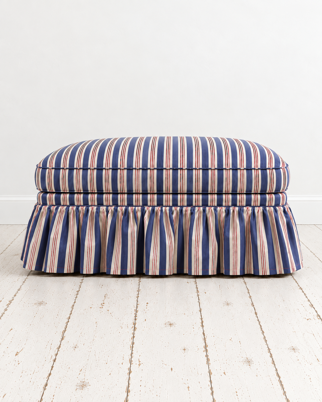 Navy Striped Skirted Ottoman in Minimal Studio.png