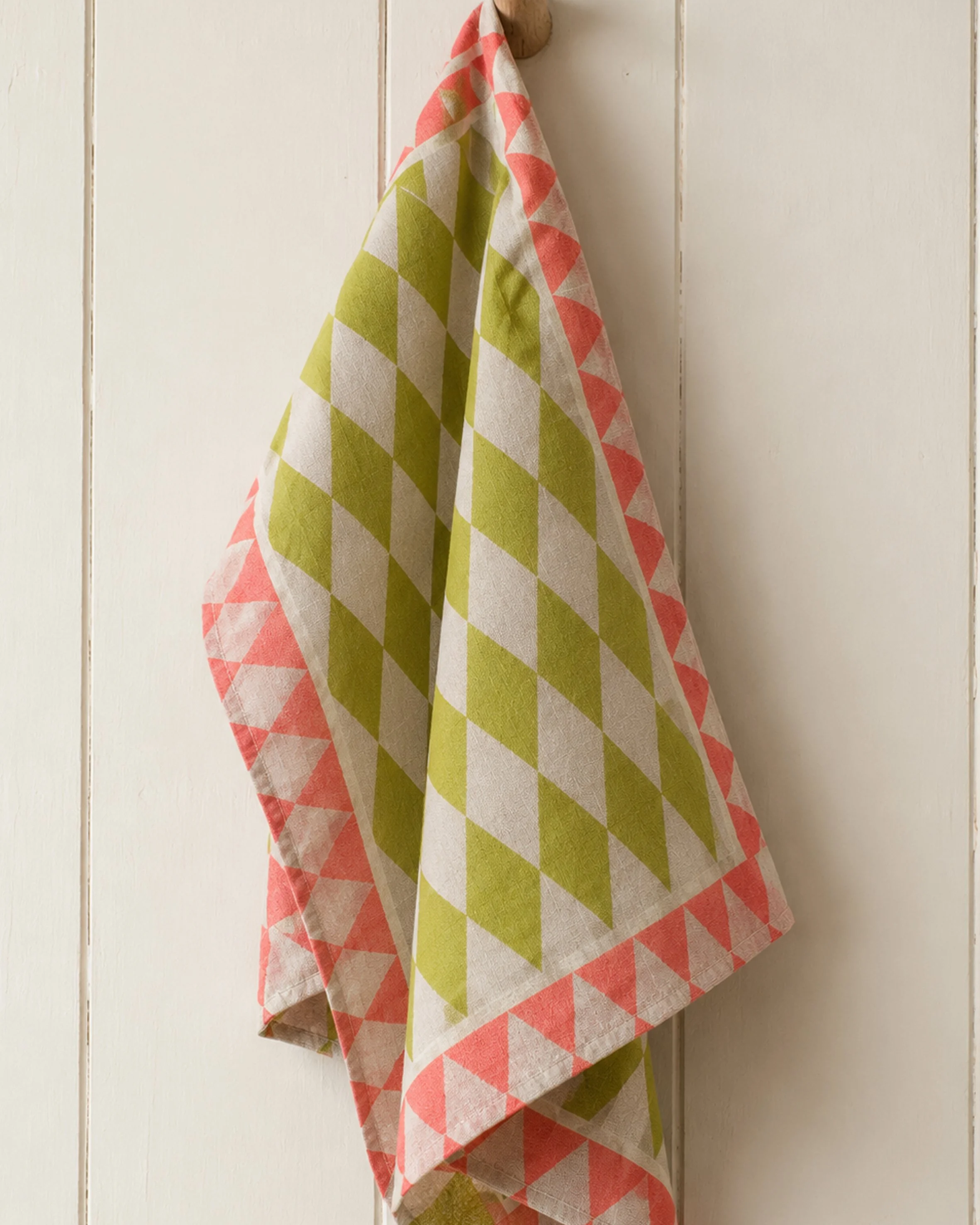 harlequin yellow and pink tea towelon peg.jpg