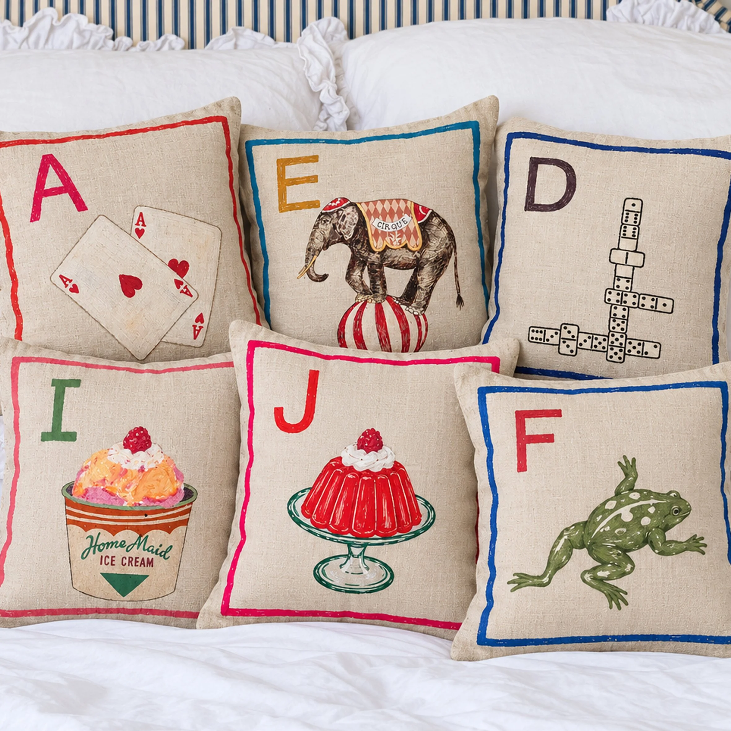 alphabet cushions on bed.jpg