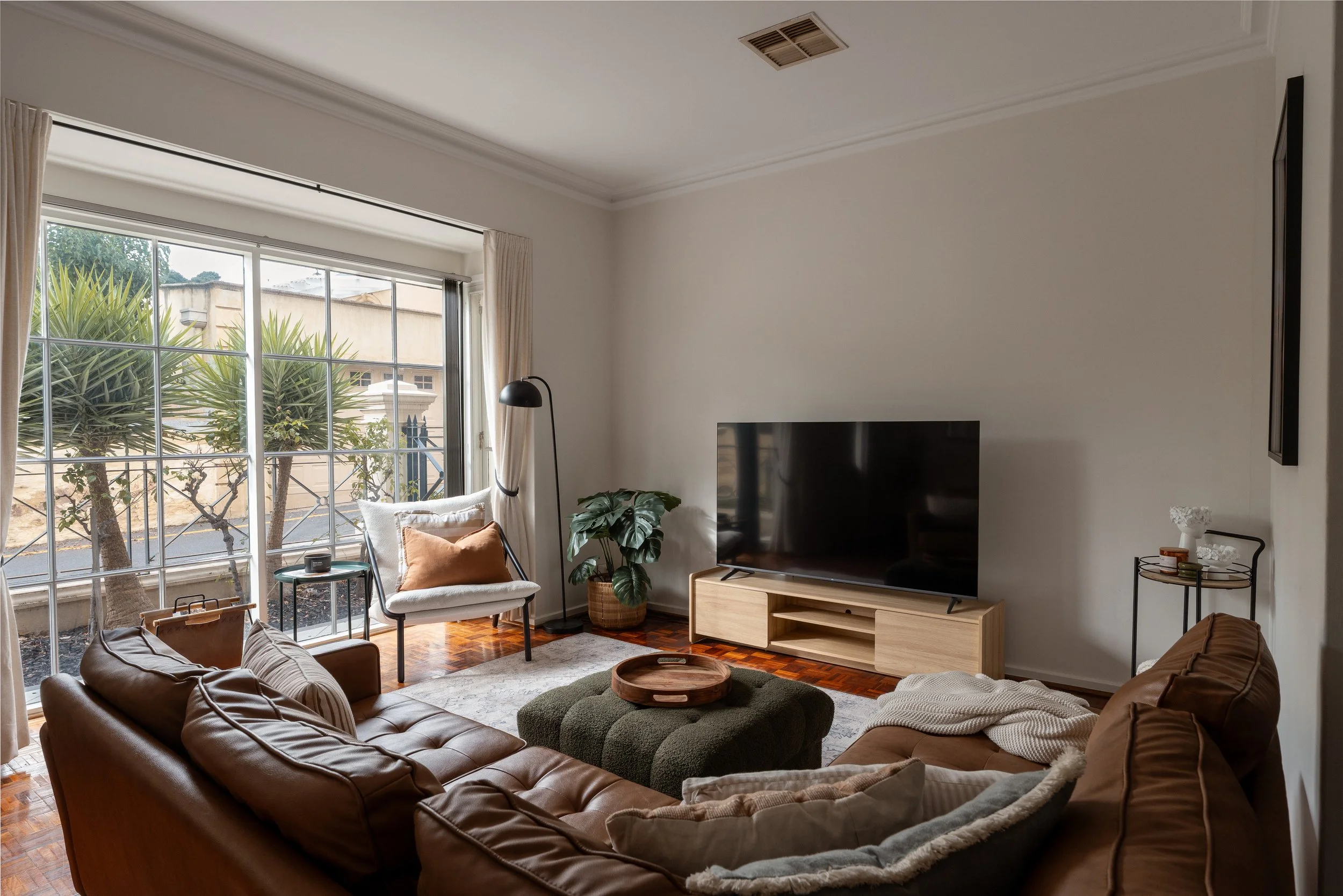 dining room area in apartment in Adelaide, Airbnb short stay. Overlooking Victoria Square with balcony and bedroom behind the dining area