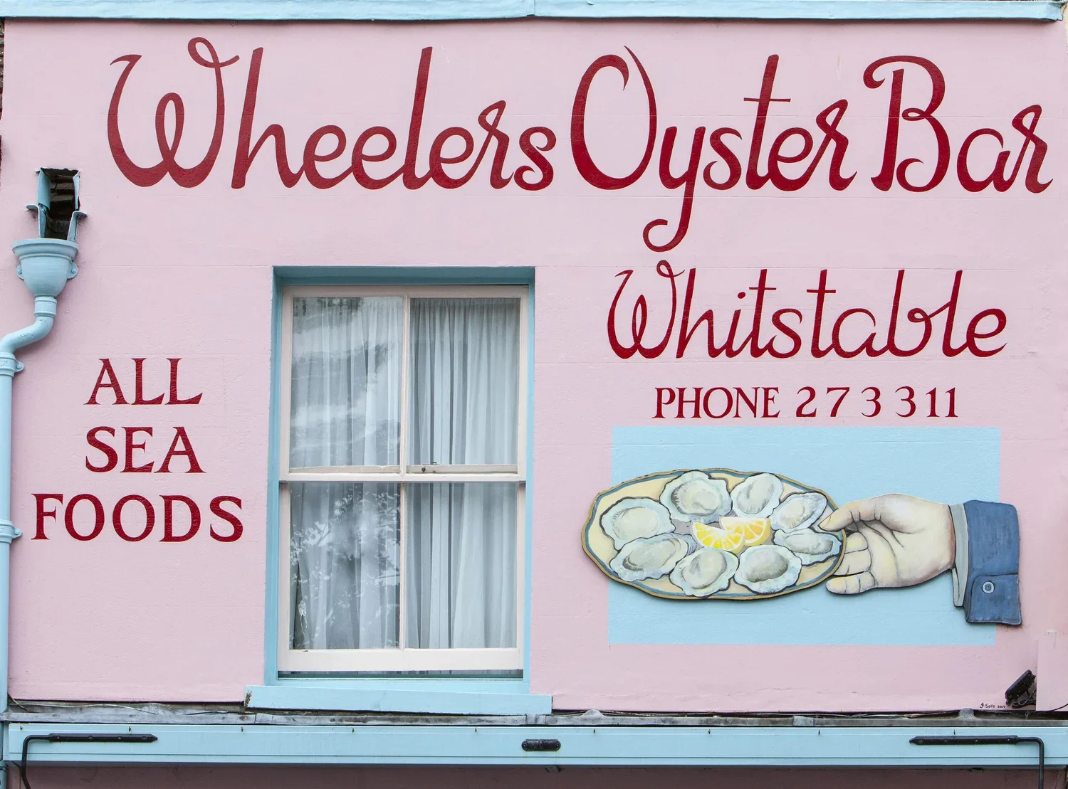The iconic pink facade of Wheelers Oyster Bar in Whistable UK