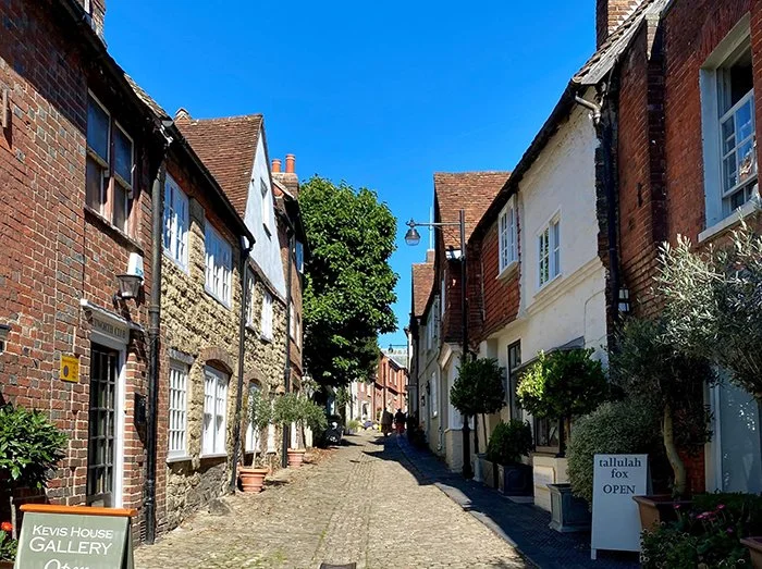 Pretty shop fronts on cobbled Lombard Street in Petworth UK