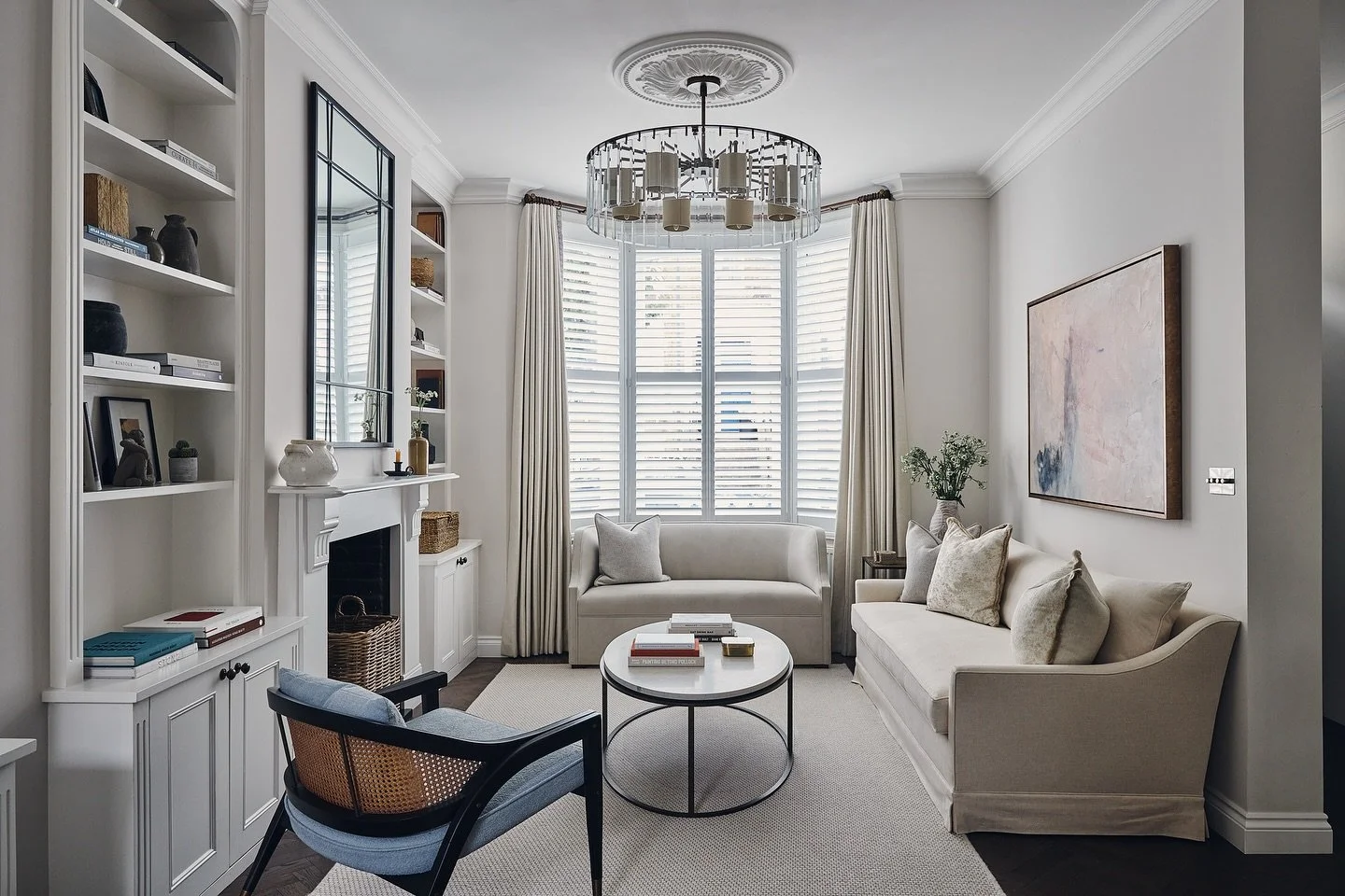 Top tip: arrange your seating so it invites conversation.

Even in this compact Fulham living room, we created balance with three different types of seating around a central coffee table: a bespoke loveseat in the bay window, a skirted sofa, and a pa