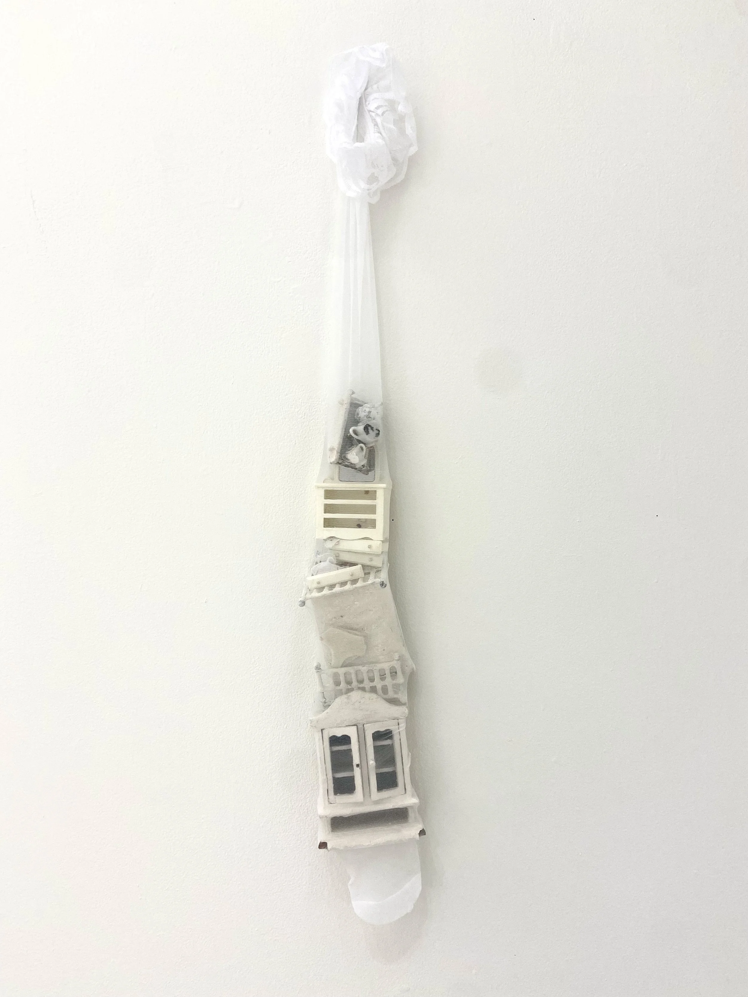 Stocking, 2024, paint, plaster, doll furniture, reused textile, 36" x 4" x 3"