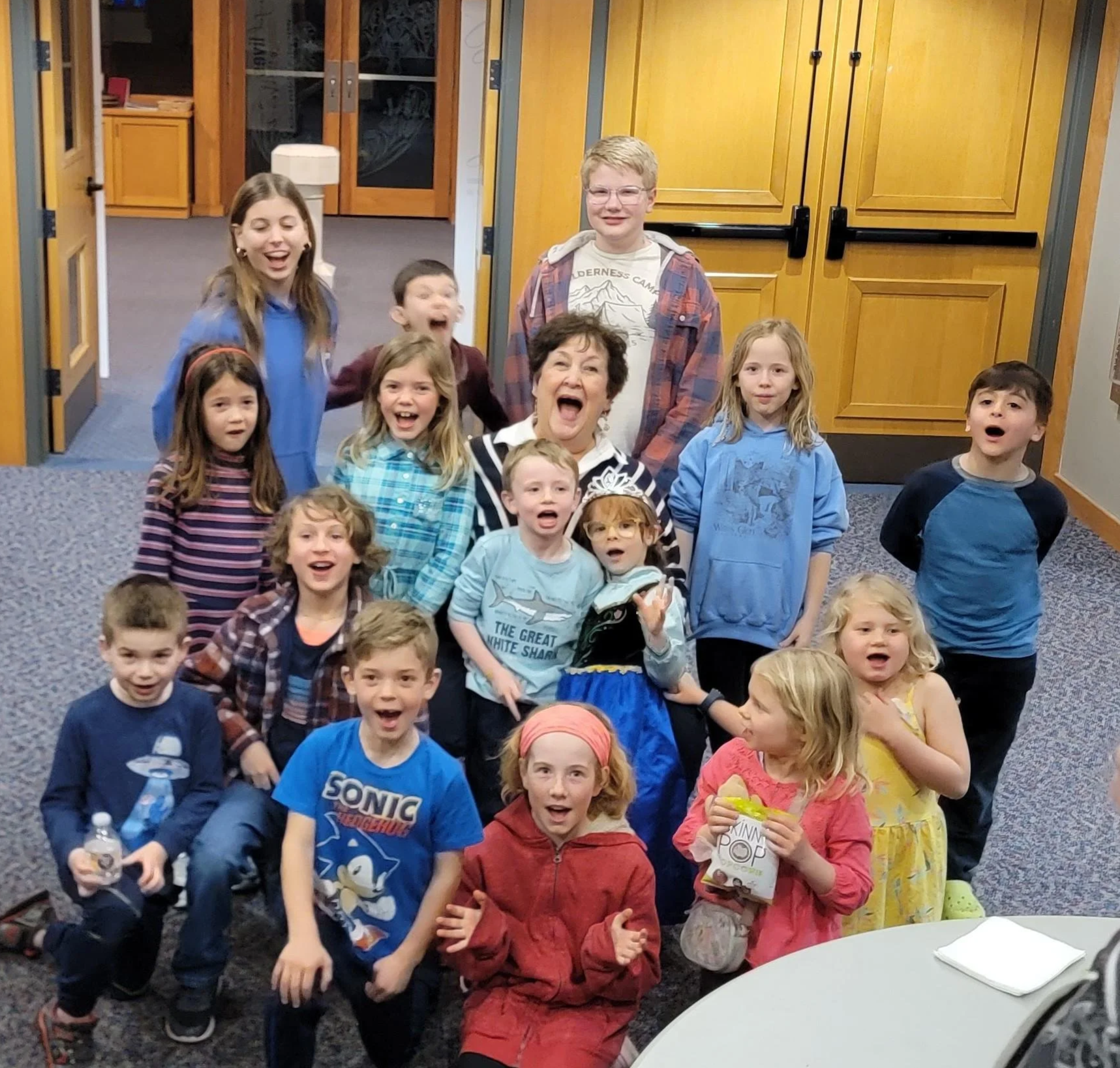 Children celebrating with their music teacher