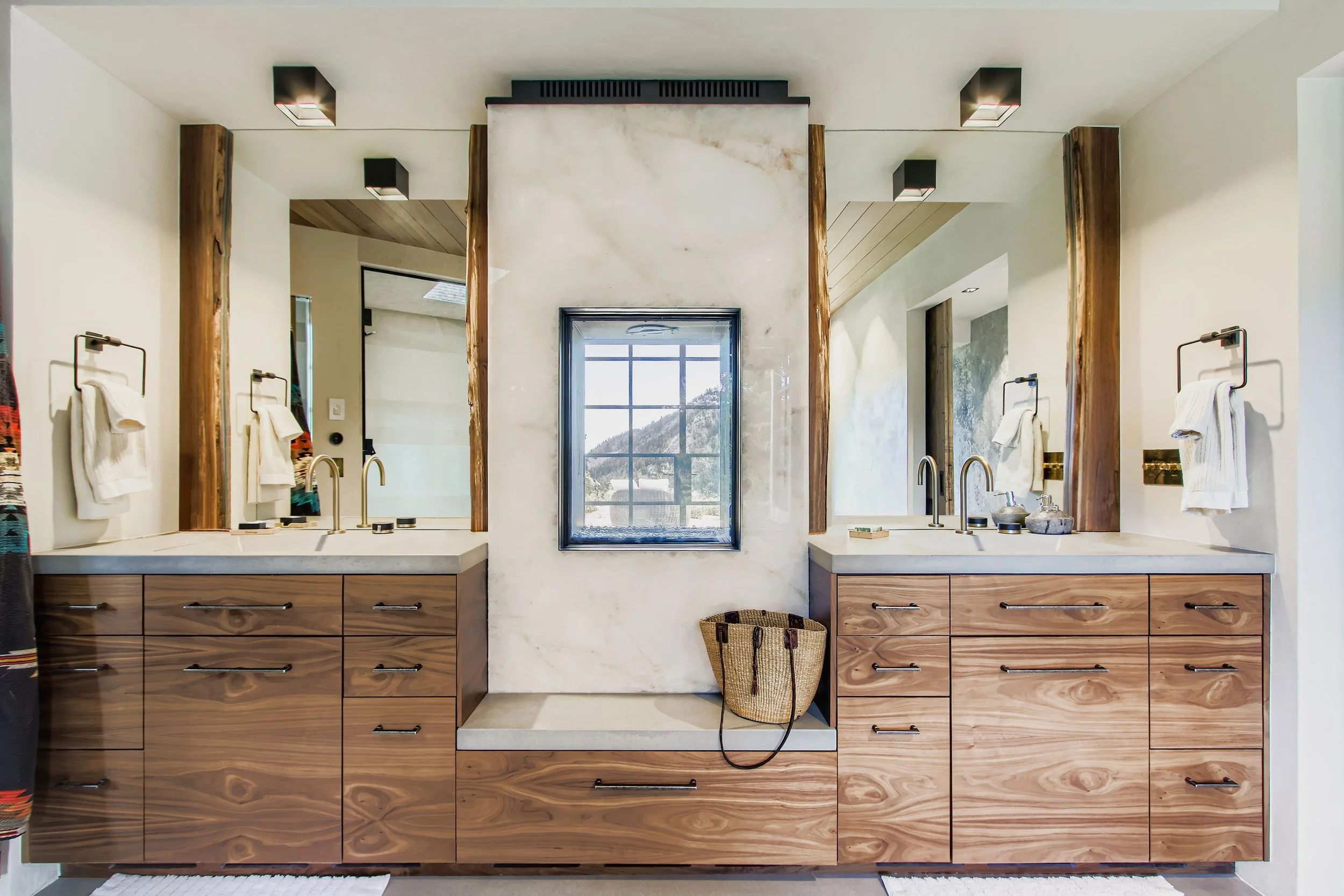 Bathroom at Onyx Ridge, Boulder County, CO, with double vanity, and large mirrors, wooden cabinets.