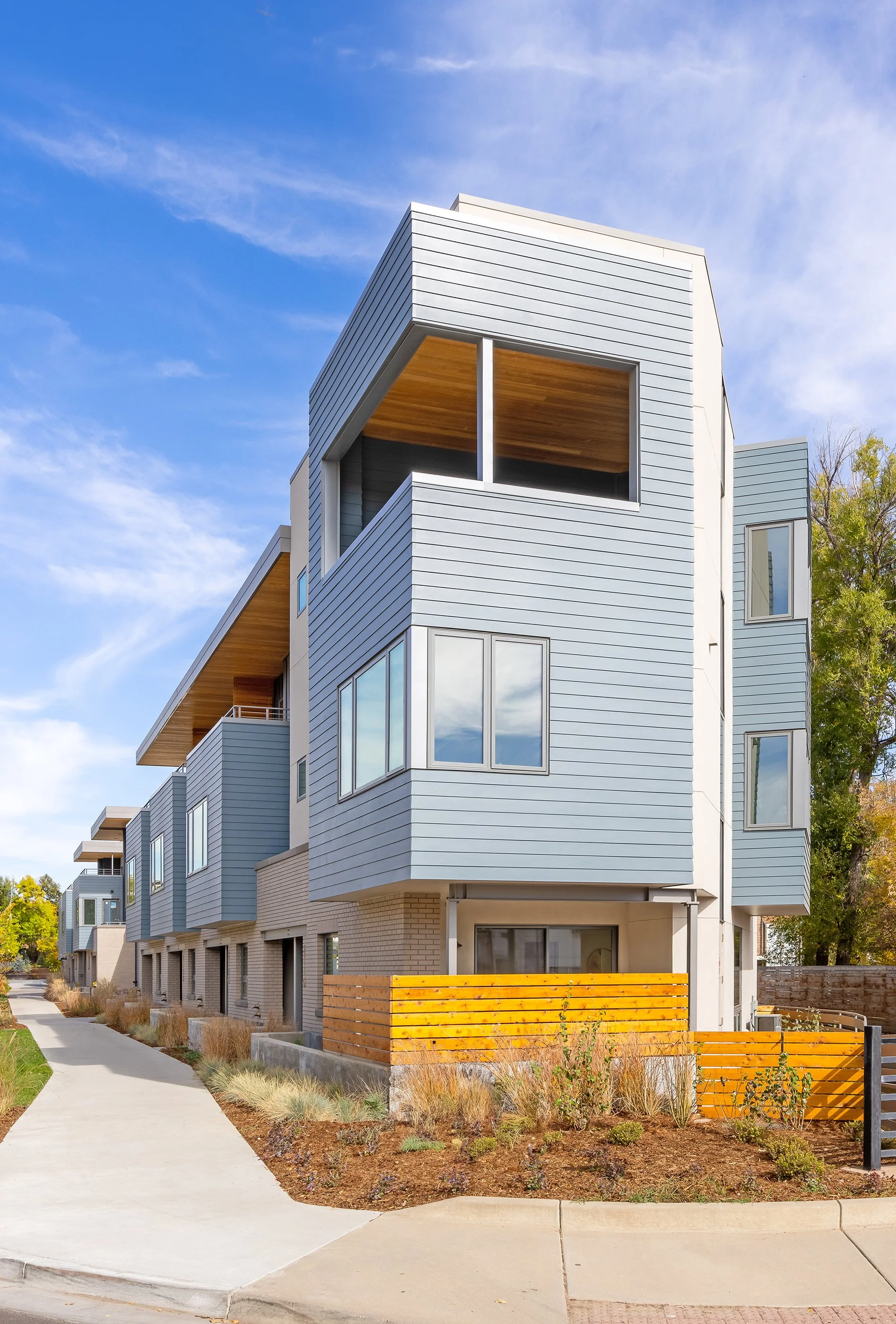Flatiron Vista residential building in Boulder, Colorado, with contemporary siding, large windows, and wood-accented balconies.