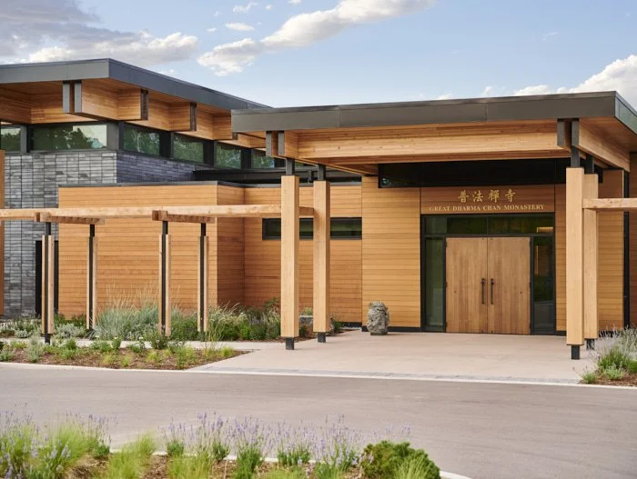 Exterior view of the Great Dharma Chan Monastery in Boulder, Colorado, showcasing sustainable wood and stone design elements, energy-efficient architecture, and Sopher Sparn Architects’ focus on environmentally conscious construction.