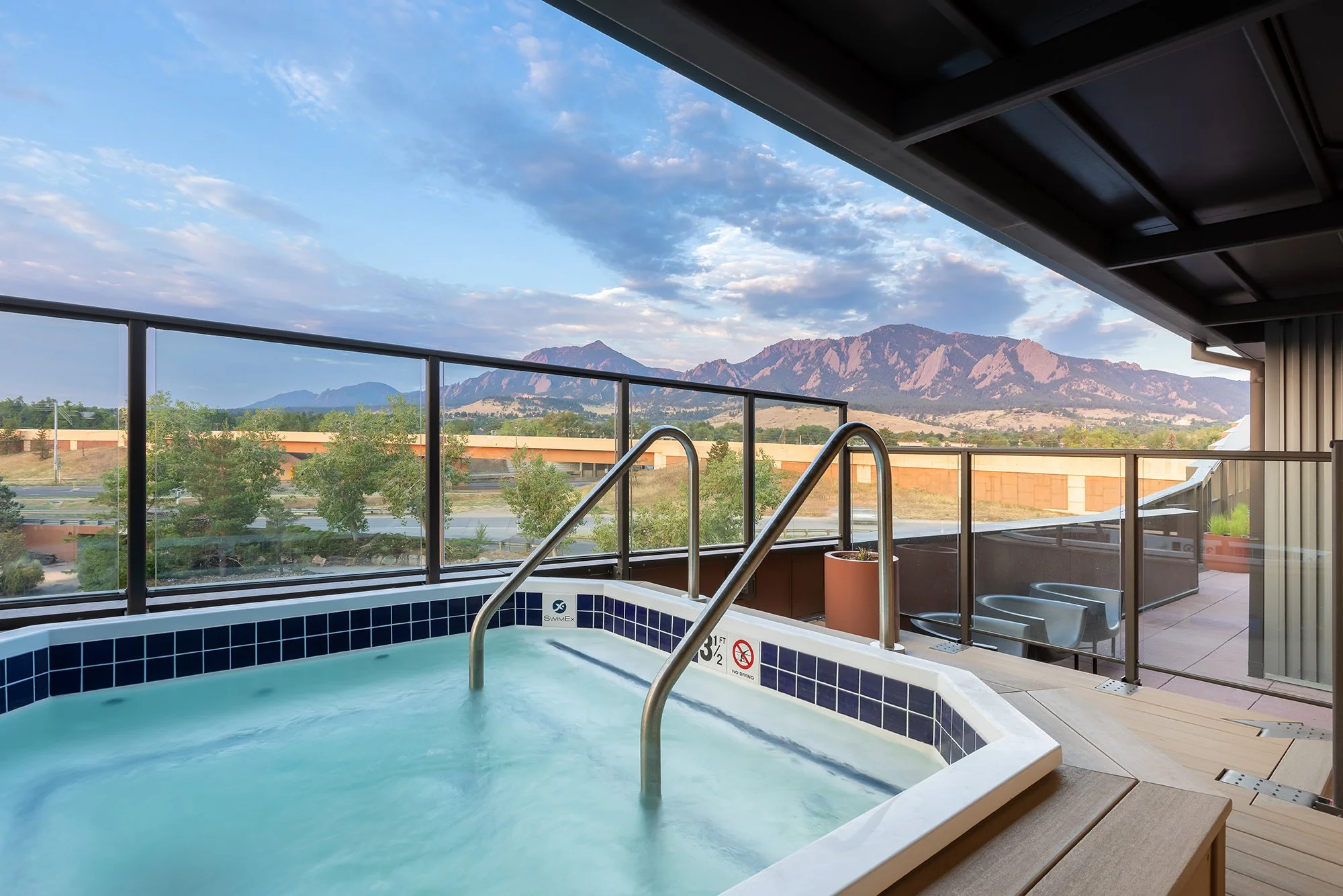 HUB 28th Street rooftop pool and terrace with lounge seating and expansive views of Boulder and the Flatirons.
