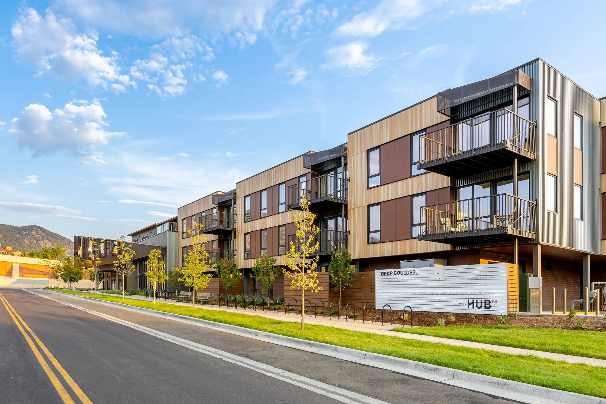 HUB 28th Street residential exterior with contemporary facade materials, balconies, and landscaped streetscape.