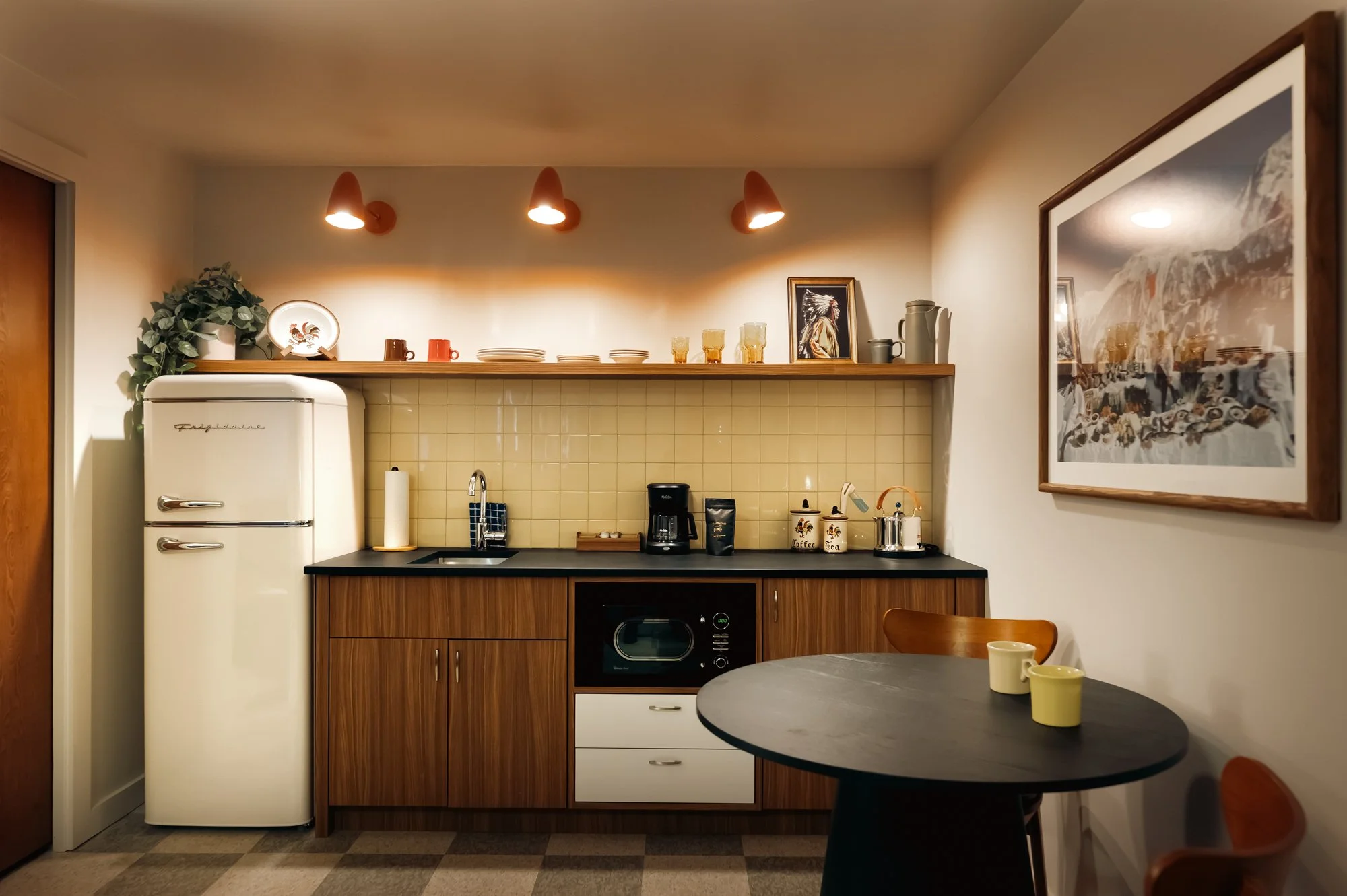 Kitchen interior at La Vista Motel in Denver, CO with modern cabinetry, pendant lights, and counter seating.