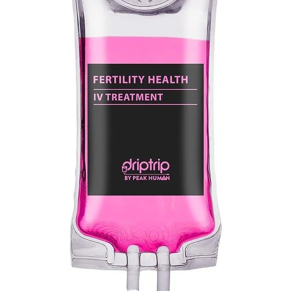 IV drip bag labeled 'Fertility Health IV Treatment' with pink liquid, branded by Peak Human.