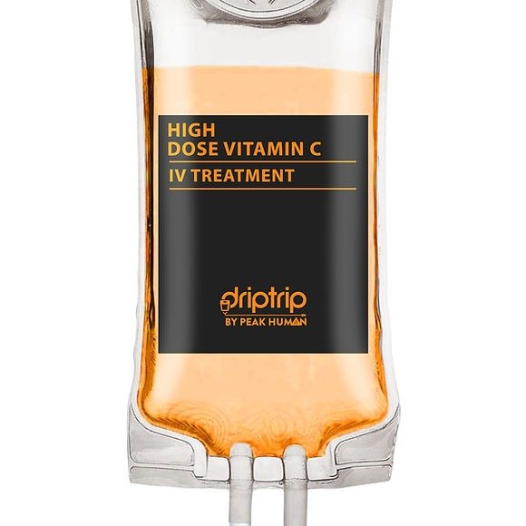 A medical IV bag labeled 'High Dose Vitamin C IV Treatment' by Driptrip, a product by Peak Human, containing an orange liquid.
