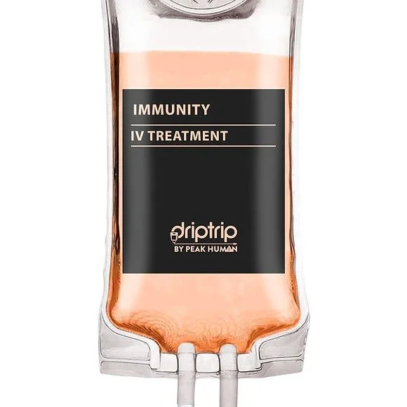 A medical IV bag labeled 'Immunity IV Treatment' from Driptrip by Peak Human, filled with a pinkish liquid.