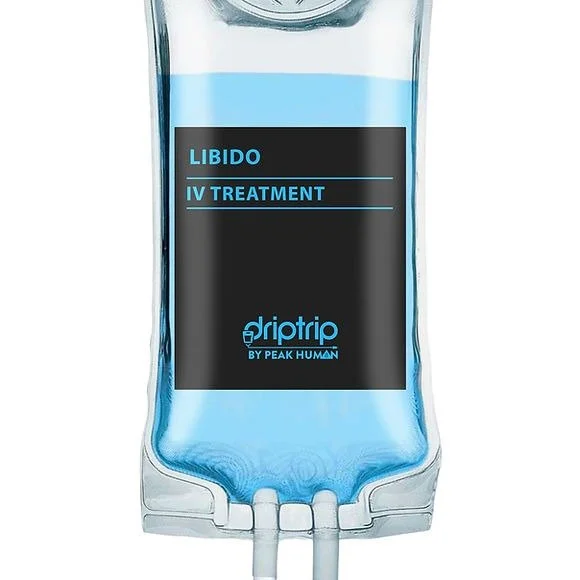 A transparent IV bag filled with blue liquid labeled 'Libido IV Treatment by Driptrip by Peak Human'.