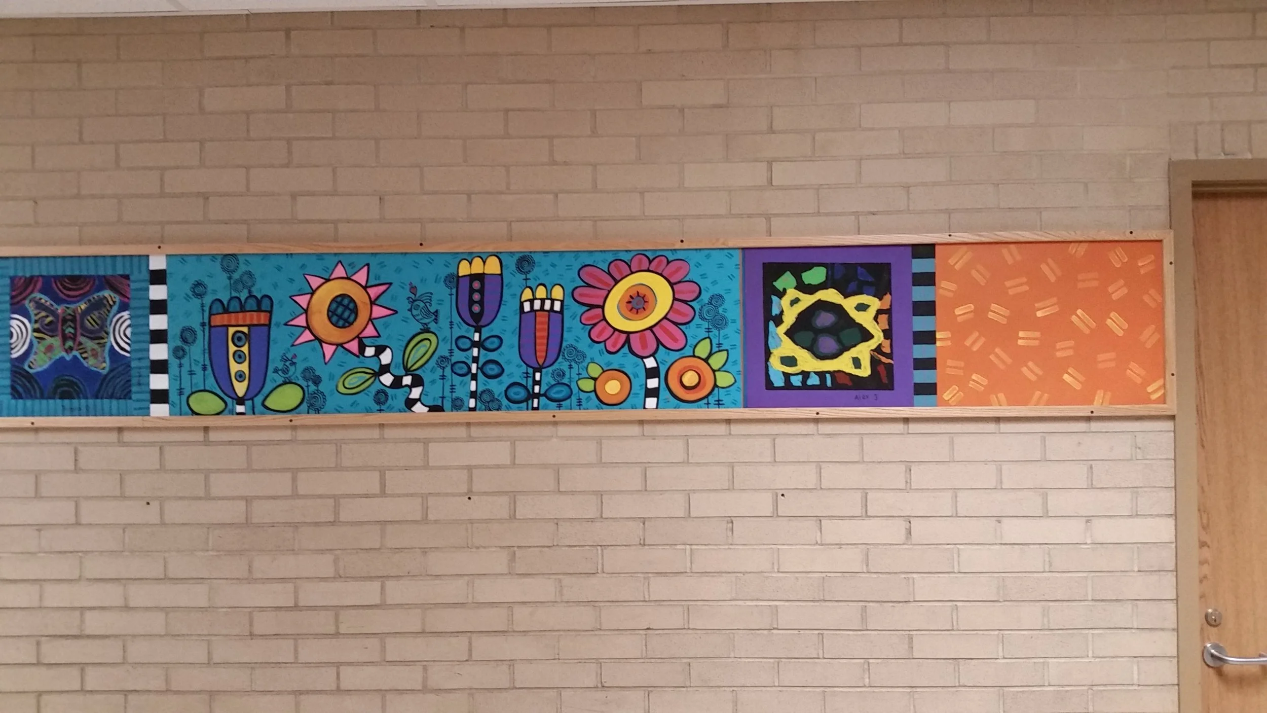 4th Grade tiles mixed with my work using acrylic paint on masonite panels to break up really long beige hallways- Madison Community School, 2017