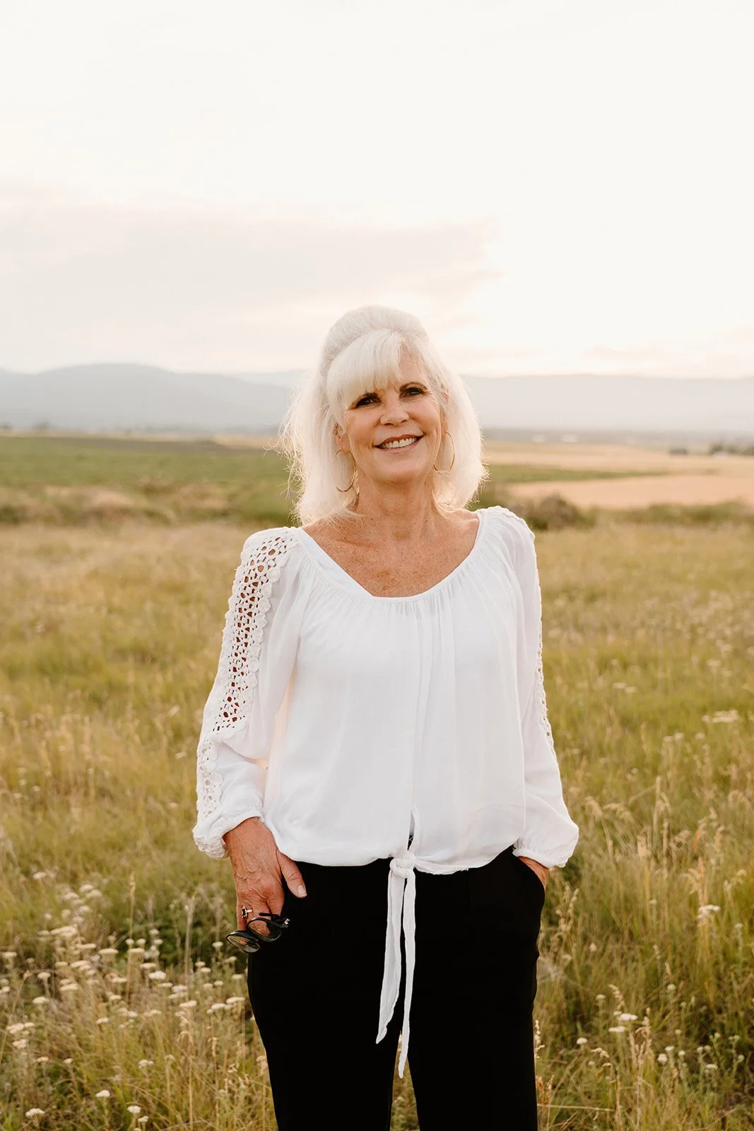 smiling woman with short hair in outdoor setting