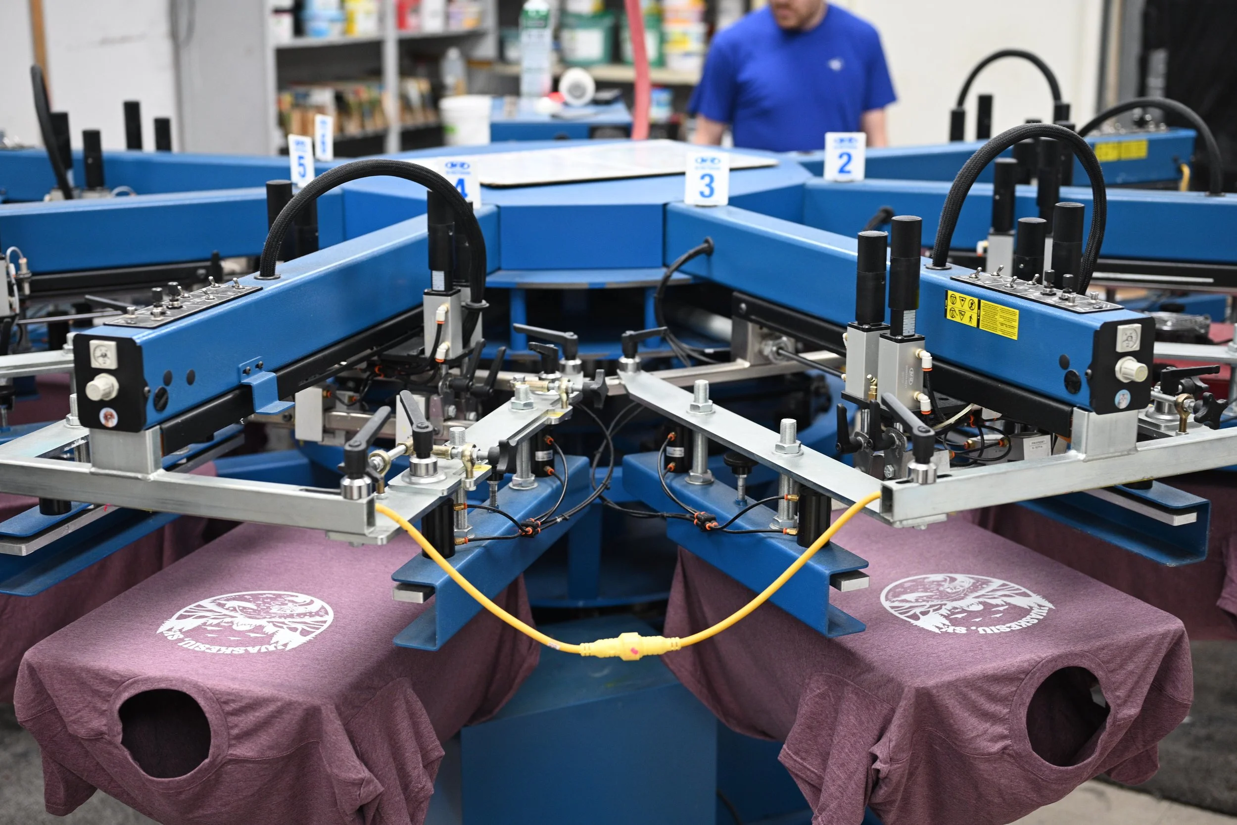 An image of machines screen printing.