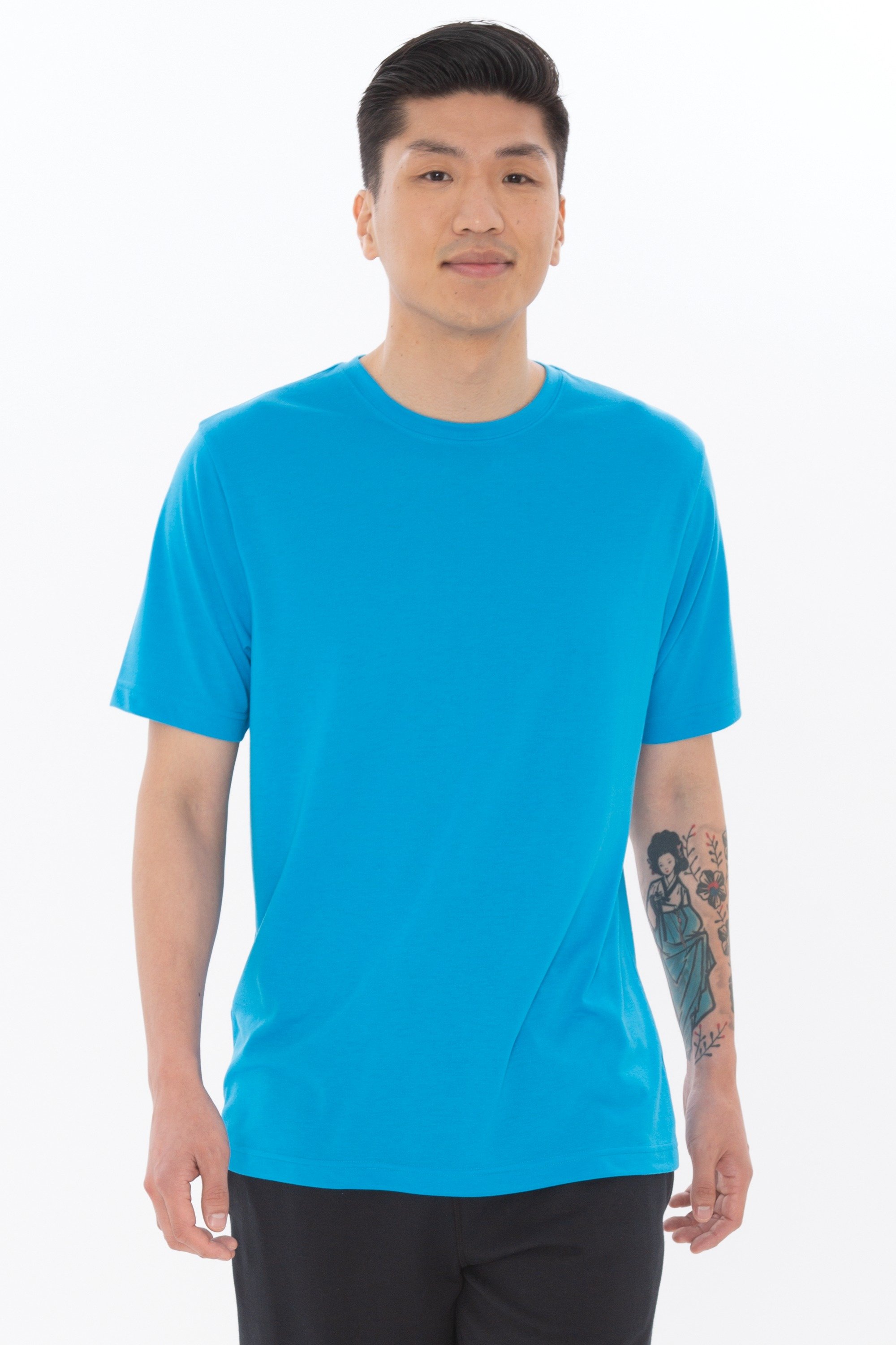 A model wearing ATC3600 Pro Spun Tee