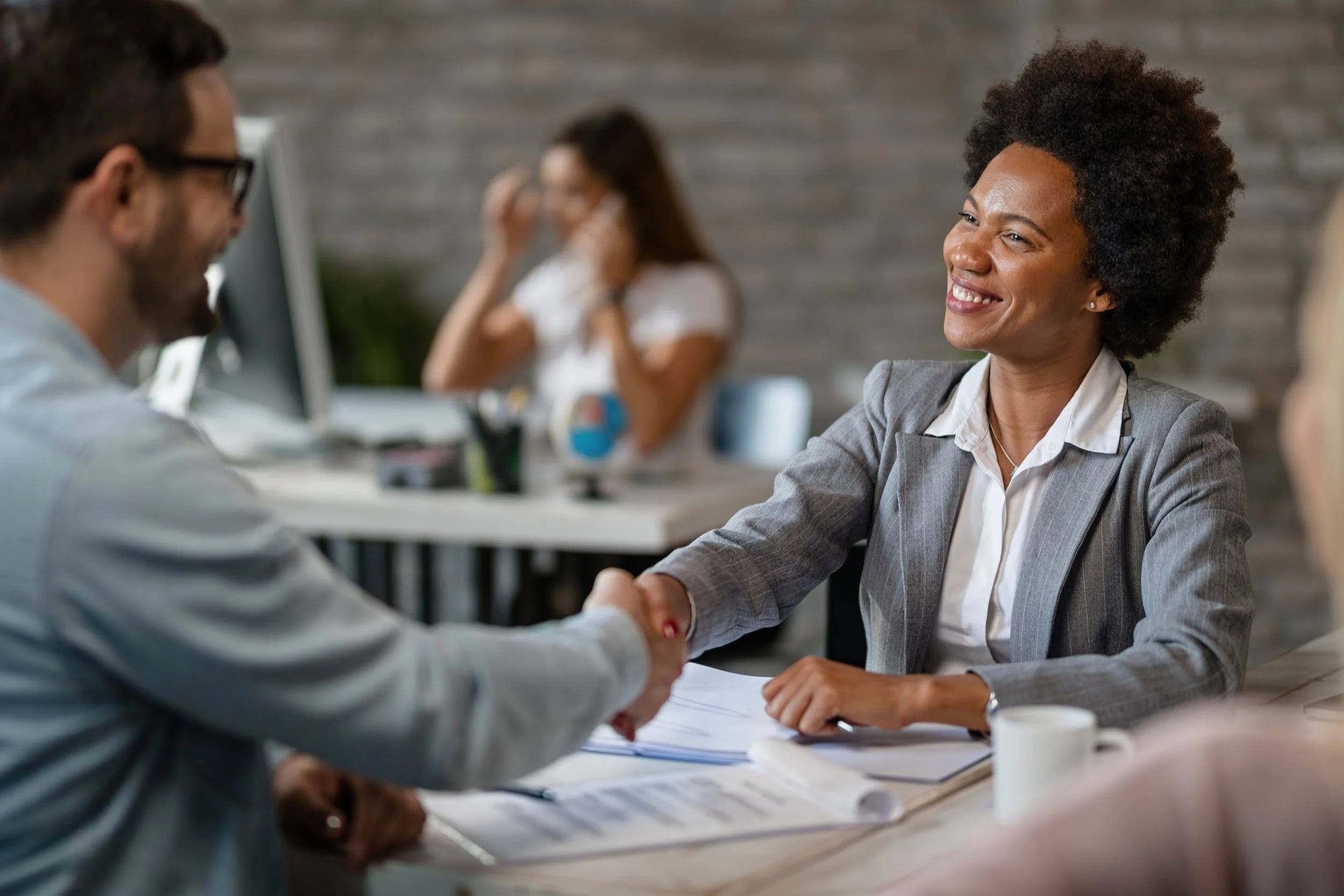 happy-african-american-bank-manager-shaking-hands-with-client-after-successful-agreement-office.jpg