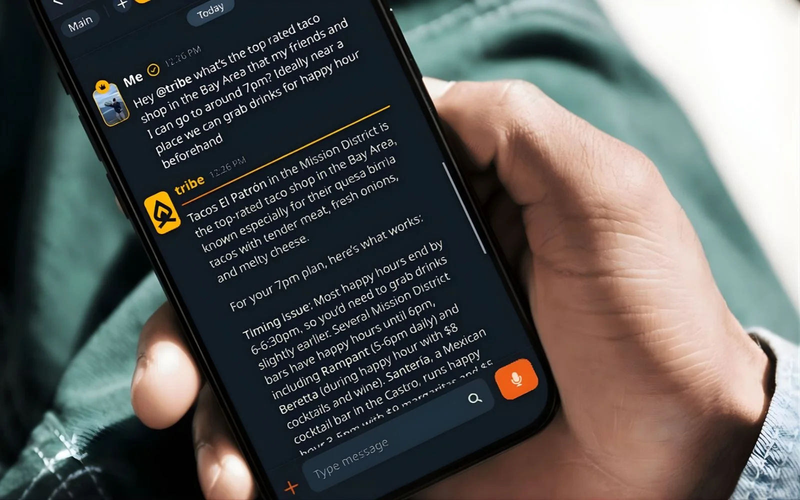 Person holding a smartphone displaying the Tribe AI chat interface, showing a conversation about finding a top-rated taco shop in the Bay Area and planning happy hour drinks.