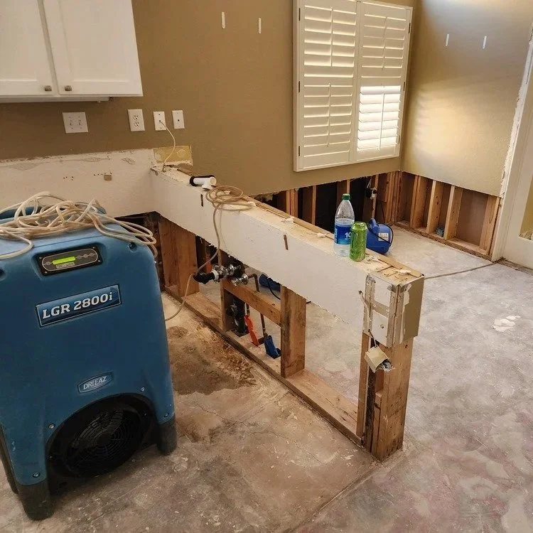 A professional technician inspecting a residential air conditioning unit in Goodyear, Arizona, to ensure proper drainage and prevent mold.