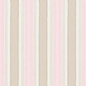 The pattern features vertical stripes in muted tones of beige and pink, creating a calming and understated look. The stripes are evenly spaced, with a subtle texture that adds depth to the design with a feel of desert ranch or coastal farmhouse
