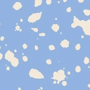 Loose, inky splashes and dots in yellow cream are scattered across a summer blue ground, creating an abstract, organic, allover “ink splatter” look that feels modern, playful, and slightly stone-like.