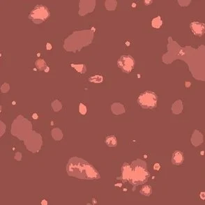 Loose, inky splashes and dots in muted terracotta and clay are scattered across a terracotta ground, creating an abstract, organic, allover “ink splatter” look that feels modern, earthy, and stone-like.