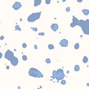 Loose, inky splashes and dots in summer baby blue are scattered across a cream ground, creating an abstract, organic, allover “ink splatter” look that feels modern, playful, and slightly stone-like.