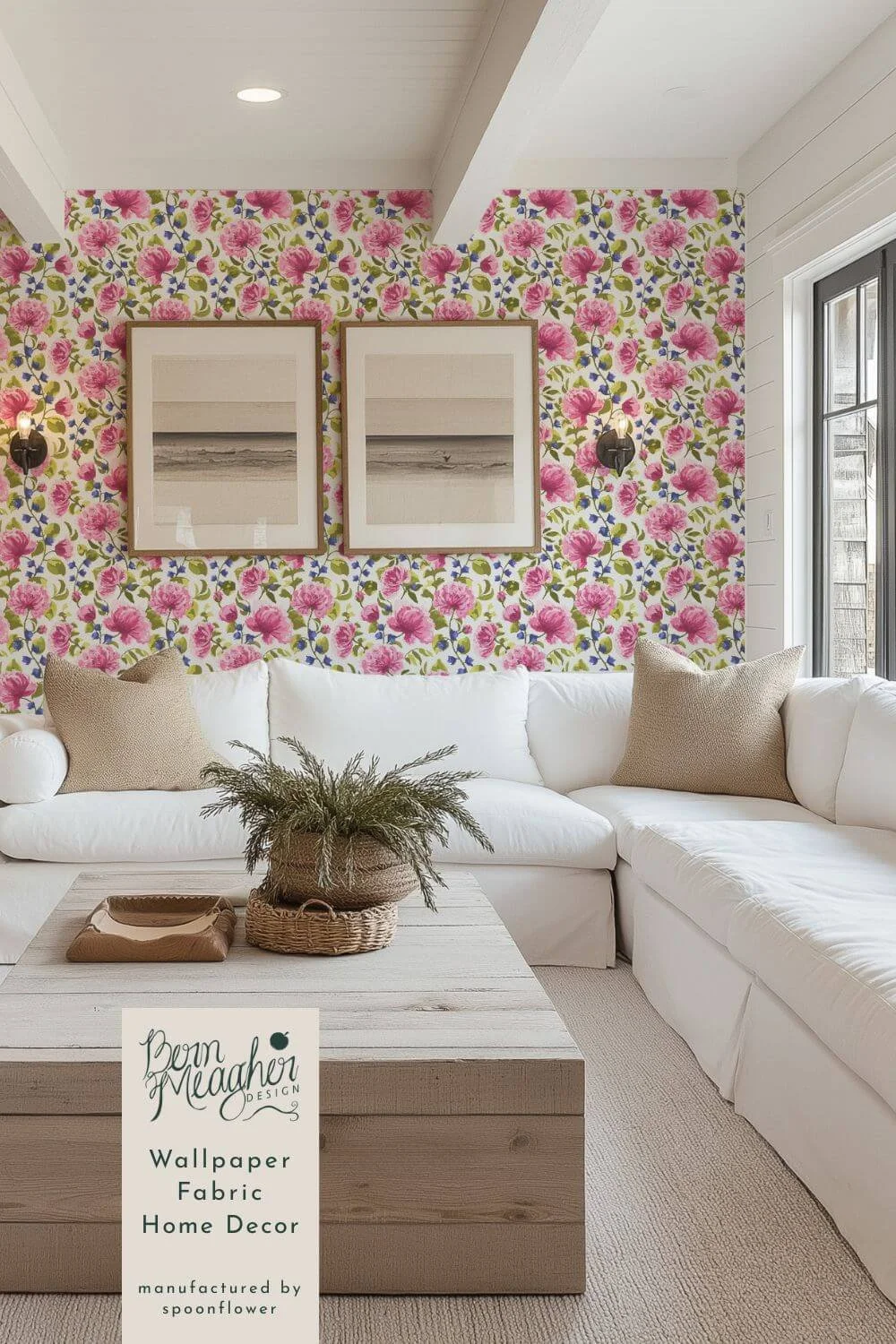 Bright pink peony floral peel-and-stick wallpaper in a farmhouse living room behind a white slipcovered sectional, light wood coffee table with woven basket, neutral pillows. Traditional English country/ cottagecore in pink, blue and green