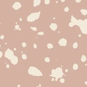 Loose, inky splashes and dots in yellow cream are scattered across a warm blush pink ground, creating an abstract, organic, allover “ink splatter” look that feels modern, playful, and slightly stone-like.