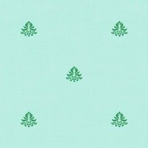 the design features a minimal, symmetrical layout with small, evenly spaced decorative green botanical elements on an aqua blue background. The artistry technique has a wood block impression with a subtle, understated texture.