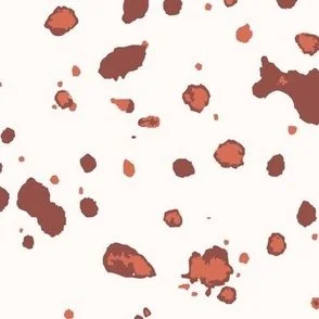 Loose, inky splashes and dots in muted clay and dark terracotta are scattered across a cream ground, creating an abstract, organic, allover “ink splatter” look that feels modern, airy, and stone-like.