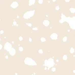 Loose, inky splashes and dots in yellow cream are scattered across a pale peach beige ground, creating an abstract, organic, allover “ink splatter” look that feels modern, playful, and slightly stone-like.