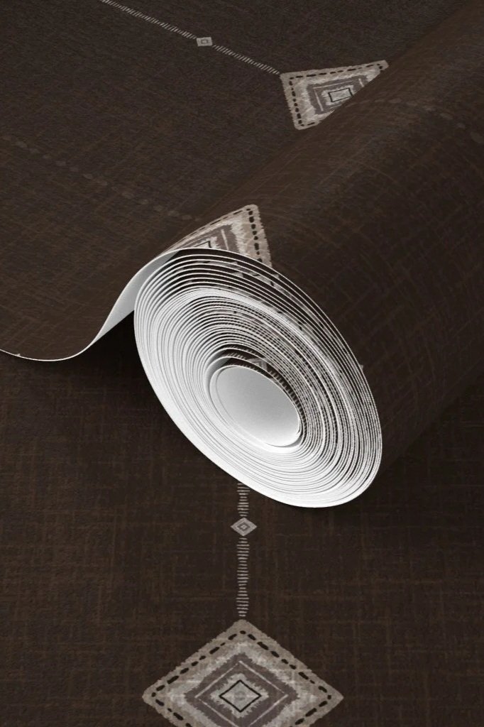 close up of wallpaper roll featuring darkest brown espresso with boho geometric diamonds hanging on a painted chain