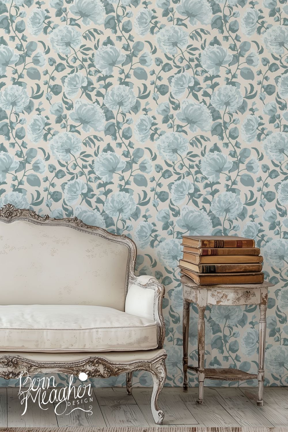 peel and stick wallpaper featuring muted blue trailing peony blooms on cottage cream behind a vintage cream settee and small old wooden table with old books