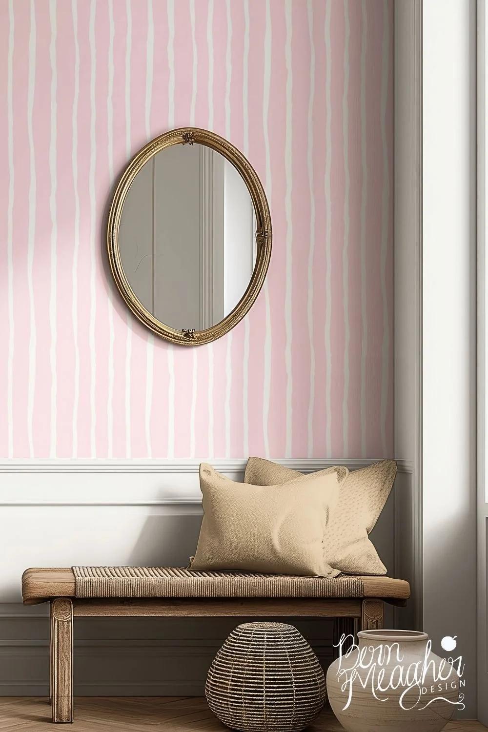 Soft pink and cream wavy striped wallpaper in a cozy entryway setting with a wooden bench, beige pillows and an antique oval mirror,