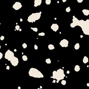 Loose, inky splashes and dots in yellow cream are scattered across a black ground, creating an abstract, organic, allover “ink splatter” look that feels modern, playful, and slightly stone-like.