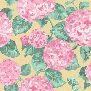 Large painterly pink hydrangea flowers with layered brushstroke-style petals and teal-green leaves are scattered densely across a butter yellow ground, creating a bold, allover floral with a fresh, romantic, slightly vintage vibe.
