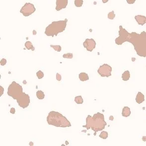 Loose, inky splashes and dots in warm blush pink are scattered across a cream ground, creating an abstract, organic, allover “ink splatter” look that feels modern, playful, and slightly stone-like.
