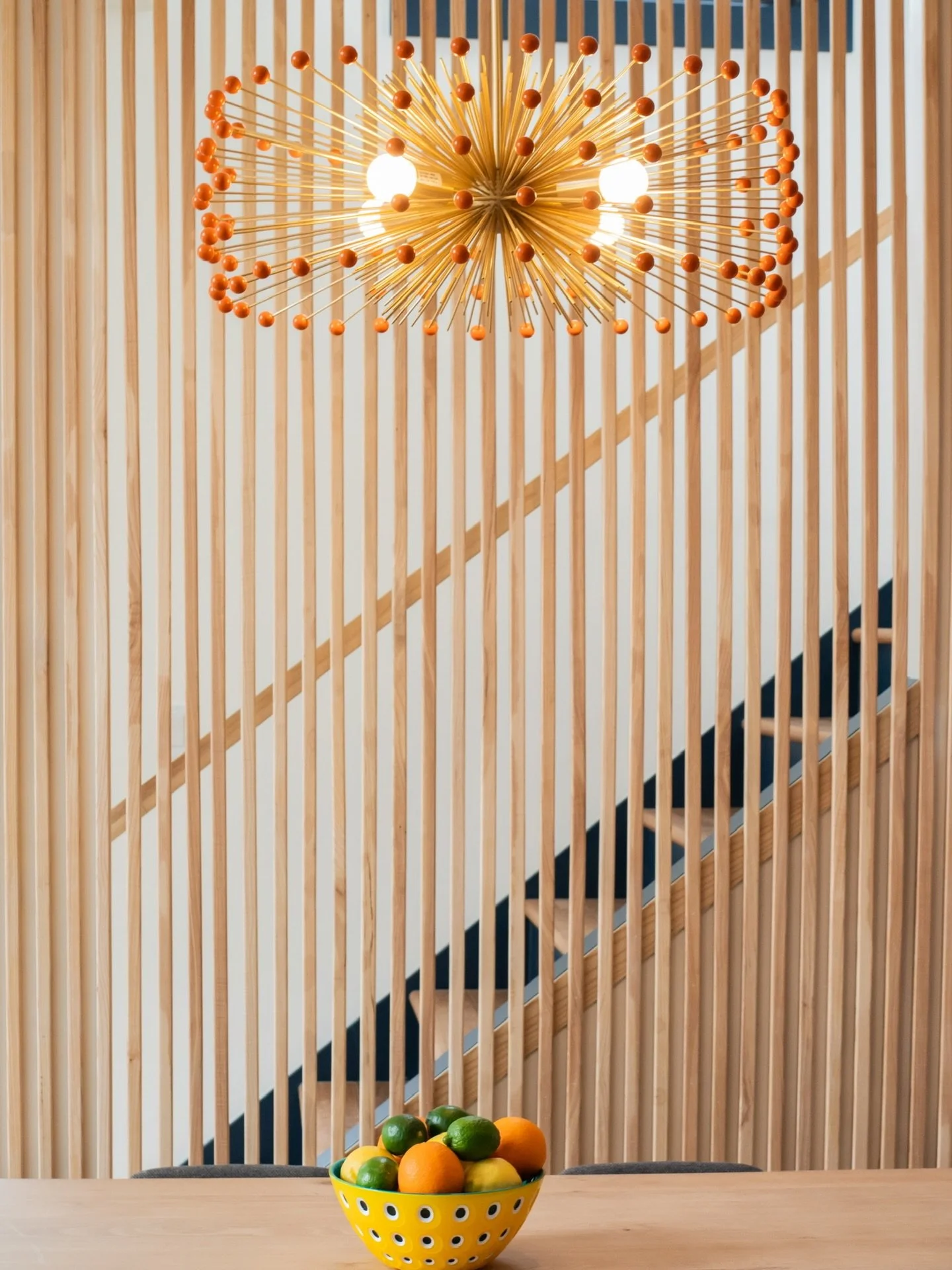 We wanted this space to feel open, warm, and full of light&mdash;so instead of closing off the staircase, we designed a custom slat wall that lets the light pass right through.
As the sun moves throughout the day, it casts the most beautiful shadows 