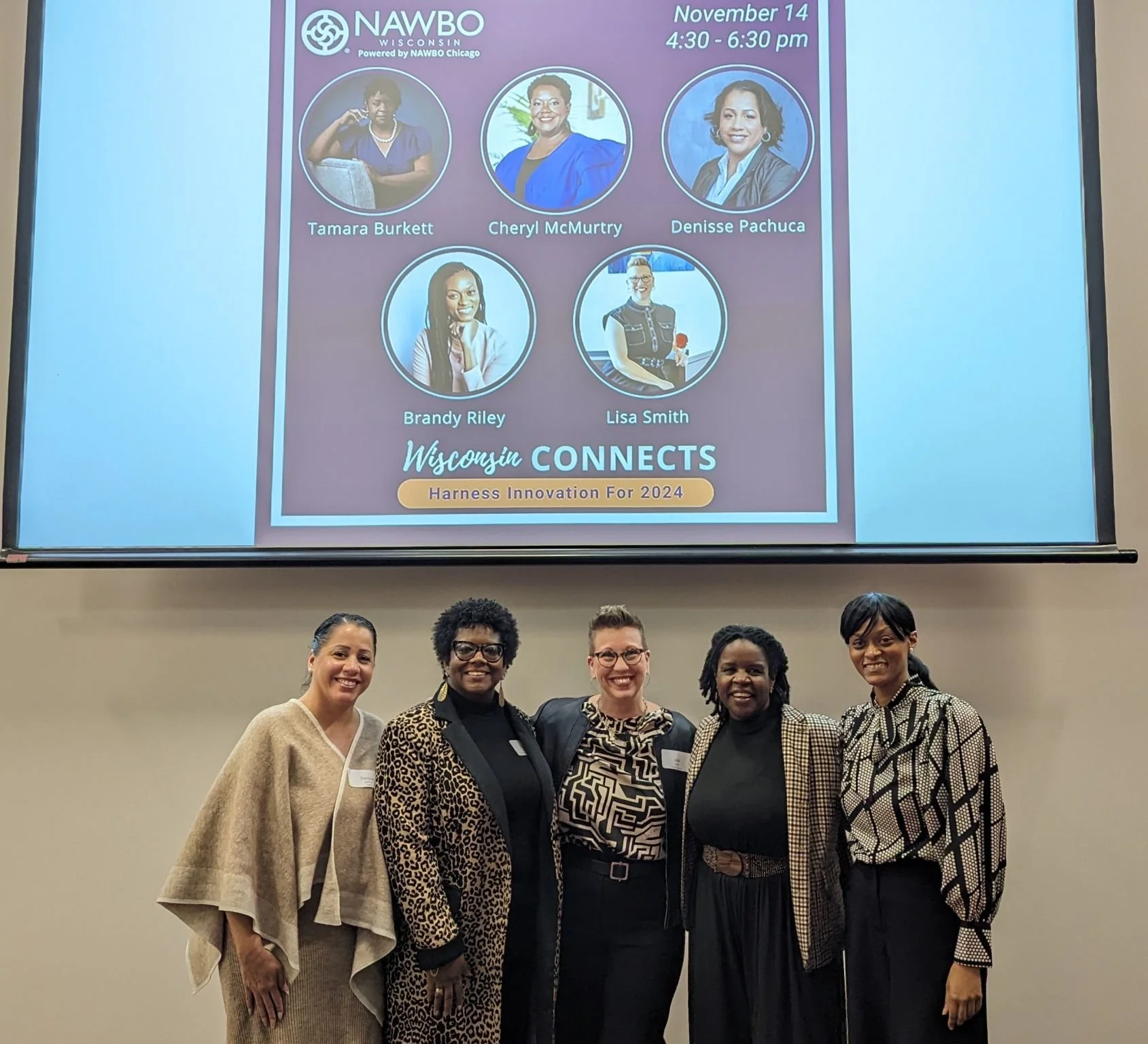 A group of 5 women smiling at an event for NAWBO Wisconsin