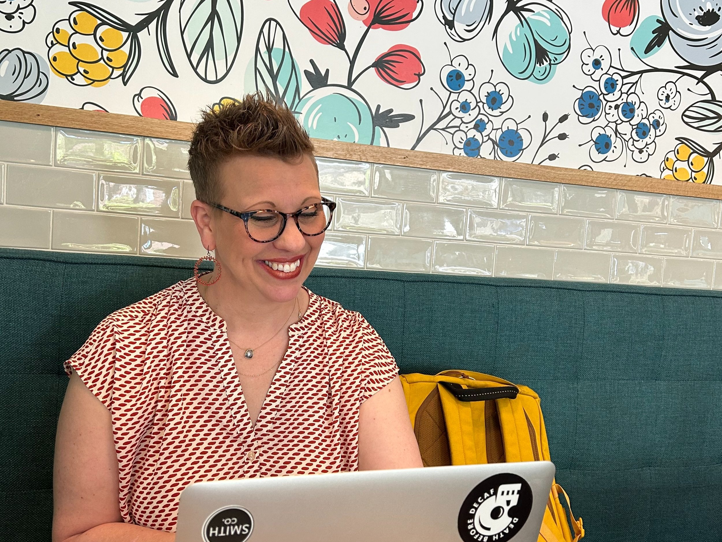 B2B executive sales coach sitting at a laptop.