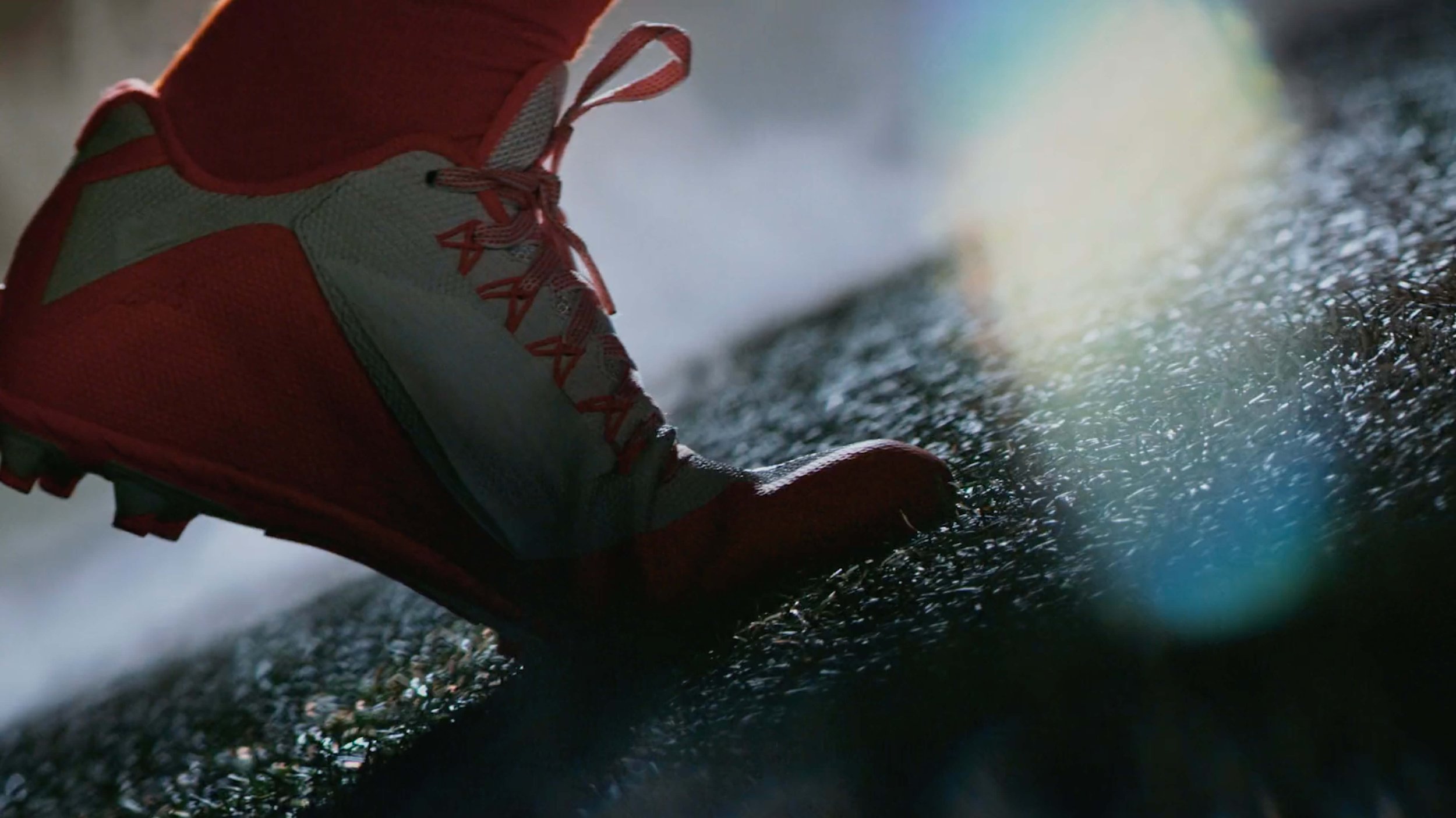 Close-up of a running shoe on a wet, textured surface.